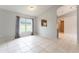 Spacious living room with tile floors, neutral walls, large window and passthrough to kitchen at 17343 Summer Oak Ln, Clermont, FL 34711