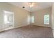 Carpeted main bedroom featuring neutral paint, ceiling fan, and ensuite bathroom at 17343 Summer Oak Ln, Clermont, FL 34711