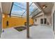 Screened-in patio featuring decorative plant beds and neutral color scheme at 17343 Summer Oak Ln, Clermont, FL 34711