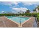 Relaxing community pool surrounded by lush landscaping and comfortable lounge chairs on a sunny day at 17343 Summer Oak Ln, Clermont, FL 34711