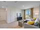 Comfortable living room featuring plush carpet, neutral tones, natural light, and modern furniture at 1865 Walnut Creek Dr, Kissimmee, FL 34744