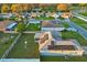 Aerial view of the home's backyard with solar panels, fenced yard, and screened in patio at 1879 Grey Fox Dr, Lakeland, FL 33810