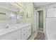 Bright bathroom with double sinks, ample vanity space, and a glass-enclosed shower at 1879 Grey Fox Dr, Lakeland, FL 33810