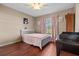 Comfortable bedroom with hardwood floors and a white bed frame at 1879 Grey Fox Dr, Lakeland, FL 33810