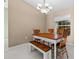 Cozy dining room with wood table and chairs, complemented by a stylish chandelier and bright natural light at 1879 Grey Fox Dr, Lakeland, FL 33810