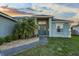 Front entrance adorned with a decorative palm tree and well-maintained landscaping at 1879 Grey Fox Dr, Lakeland, FL 33810