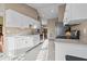 Well-lit kitchen featuring white cabinets, stainless steel appliances, and tiled flooring at 1879 Grey Fox Dr, Lakeland, FL 33810