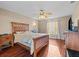 Cozy main bedroom with wood floors, ceiling fan, and a window providing natural light, creating a relaxing retreat at 1879 Grey Fox Dr, Lakeland, FL 33810