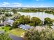 Stunning aerial view of a home, located on a beautiful lake with mature landscaping at 1890 Twin Lake Dr, Gotha, FL 34734