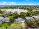 Aerial view of a home with a lakefront location, surrounded by mature trees and lush landscaping at 1890 Twin Lake Dr, Gotha, FL 34734