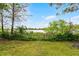 Lush backyard with a glimpse of the lake at 1890 Twin Lake Dr, Gotha, FL 34734