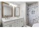 Bathroom featuring a double sink vanity with quartz counters and a tiled shower with a built-in seat at 1890 Twin Lake Dr, Gotha, FL 34734