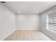 Bedroom with wood-look floors, a large window and neutral walls at 1890 Twin Lake Dr, Gotha, FL 34734