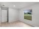 Naturally lit bedroom featuring light colored vinyl flooring and a bright window at 1890 Twin Lake Dr, Gotha, FL 34734