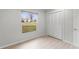 Clean bedroom with a closet and bright window at 1890 Twin Lake Dr, Gotha, FL 34734