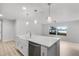 Kitchen island features a farmhouse sink, stainless steel dishwasher, and an open concept design at 1890 Twin Lake Dr, Gotha, FL 34734