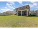 Expansive backyard view from screened in patio showcasing green lawn and exterior of home at 204 Pinecrest Rd, Mount Dora, FL 32757