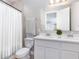 Clean, bright bathroom featuring double sink vanity with white cabinets and a shower with white shower curtain at 204 Pinecrest Rd, Mount Dora, FL 32757