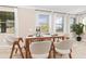 Light-filled dining area with stylish modern table set, bright white walls, and multiple windows at 204 Pine Crest Rd, Mount Dora, FL 32757