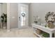 Bright foyer featuring decorative wreaths, a decorative entry door, and wood-look flooring at 204 Pine Crest Rd, Mount Dora, FL 32757