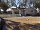 Exterior side view of a cozy home with a white picket fence and foliage at 204 S Center St, Eustis, FL 32726