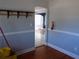 Hallway with blue wainscoting, hardwood floors and an arched doorway leading to another room at 204 S Center St, Eustis, FL 32726