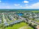 Aerial view of neighborhood near lake showcasing community and green spaces at 20648 Maxim Pkwy Pkwy, Orlando, FL 32833