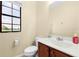 Cozy half bathroom featuring modern fixtures, vanity sink and a toilet at 20648 Maxim Pkwy Pkwy, Orlando, FL 32833