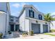 Charming townhomes with two stories, gray paint, black shutters, and attached garages at 20648 Maxim Pkwy Pkwy, Orlando, FL 32833