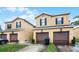 Townhome featuring a garage and a well maintained lawn at 20648 Maxim Pkwy Pkwy, Orlando, FL 32833