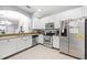 Well-lit kitchen featuring white cabinets, stainless steel appliances, and granite countertops at 20648 Maxim Pkwy Pkwy, Orlando, FL 32833