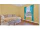 Bright bedroom with wood floors, natural light, and yellow walls at 2233 Tulip Valley Pt, Sanford, FL 32771