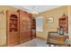 Home office with built-in shelving, decorative barrel, and window at 2233 Tulip Valley Pt, Sanford, FL 32771