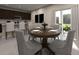 Open concept dining area with wood table, elegant chairs, and sliding glass doors leading to an outdoor patio at 2318 White Tail St, Davenport, FL 33837