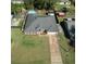 Aerial view of a well-maintained home with a spacious yard, pool, shed, and long driveway, showcasing its desirable location at 2454 Whitehorse St, Deltona, FL 32738