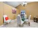 Bright dining area featuring a glass-top table, white chairs, and access to an adjacent living area at 2454 Whitehorse St, Deltona, FL 32738