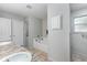 Bright main bathroom featuring a soaking tub, dual sink, and tile floors at 2454 Whitehorse St, Deltona, FL 32738