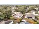 Aerial view showing the house surrounded by trees, a fenced yard and neighborhood at 250 Ryans Ridge Ave, Eustis, FL 32726