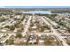 Aerial view showcasing a residential area with a lake and tree-lined streets at 250 Ryans Ridge Ave, Eustis, FL 32726