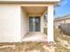 A covered back porch featuring a sliding glass door and a textured stucco exterior at 250 Ryans Ridge Ave, Eustis, FL 32726