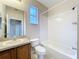 Standard bathroom featuring vanity, mirror, toilet, and shower/tub combo with white tile surround at 250 Ryans Ridge Ave, Eustis, FL 32726