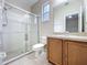 Tiled bathroom featuring walk-in shower with glass door, a sink and a toilet at 250 Ryans Ridge Ave, Eustis, FL 32726