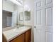 Bathroom featuring a wooden vanity with a sink and an adjacent door at 250 Ryans Ridge Ave, Eustis, FL 32726