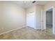 Cozy bedroom featuring neutral walls, tiled floor, and a closet with bi-fold doors at 250 Ryans Ridge Ave, Eustis, FL 32726