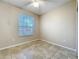 Bedroom showcasing tile flooring, ceiling fan, and window for natural light at 250 Ryans Ridge Ave, Eustis, FL 32726