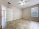 Neutral bedroom showcasing tile flooring, ceiling fan, and window for natural light at 250 Ryans Ridge Ave, Eustis, FL 32726