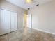 Bedroom showing tile flooring, ceiling fan, window and closet at 250 Ryans Ridge Ave, Eustis, FL 32726