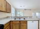 Well-lit kitchen features wooden cabinets, tile floors, and stainless steel sink at 250 Ryans Ridge Ave, Eustis, FL 32726