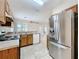 Bright kitchen featuring a stainless steel refrigerator and backyard access at 250 Ryans Ridge Ave, Eustis, FL 32726