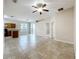 Open-concept living space with tile floors, adjoining kitchen, and sliding glass doors at 250 Ryans Ridge Ave, Eustis, FL 32726